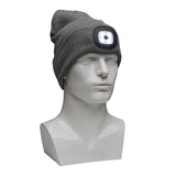 A white mannequin head is adorned with the gray PIP Winter Beanie Cap with LED light from Protective Industrial Products. The LED light is switched on, providing a bright glow ideal for cold weather protection. Designed with a slouchy fit, it comfortably covers the top of the mannequin's head.