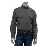 A gray PIP AR/FR Dual Certified Ripstop Long Sleeve Workshirt 385-FRRS, crafted from a Modacrylic/Cotton/Aramid blend and featuring dual chest pockets, is showcased on a mannequin. It is paired seamlessly with blue jeans and a brown belt, offering both style and enhanced safety with FR Dual Certification.