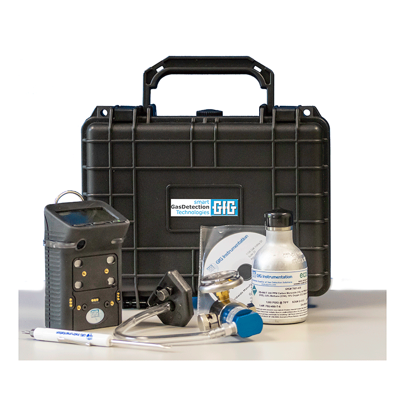 The GfG EcoBump Kit with Alkaline G450-11410E includes a sleek black carrying case, handheld alkaline gas detector, valve, calibration gas bottle, pen, and assorted tools on a white surface. This kit by GfG is ideal for safety checks in confined spaces.