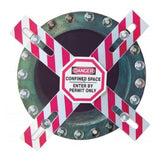 A circular metal hatch is secured by the AccuformNMC Confined Space Barrier - Enter by Permit Only CXB631, featuring an OSHA-required warning sign: "Danger: Confined Space, Enter by Permit Only." Bolts are visible around the edge.