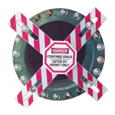 A circular metal hatch is secured by the AccuformNMC Confined Space Barrier - Enter by Permit Only CXB631, featuring an OSHA-required warning sign: "Danger: Confined Space, Enter by Permit Only." Bolts are visible around the edge.