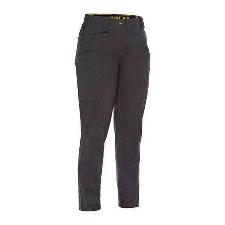 The PIP Bisley Women's Stretch Ripstop Vented Work Pants by NSA are displayed against a plain white background. These gray pants are crafted with stretch ripstop fabric for increased durability and feature multiple pockets along with UPF 50+ protection. The waistband is highlighted by yellow lettering, and they incorporate X-Airflow Ventilation to ensure breathability.