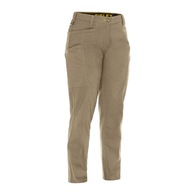 The PIP Bisley Women's Stretch Ripstop Vented Work Pants by NSA, showcasing tan cargo styling with multiple pockets, are positioned upright against a white background. Designed with UPF 50+ protection and X-Airflow Ventilation, these pants provide comfort and breathability for demanding days outdoors.