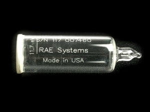 A small, transparent glass vial with a tapered end is labeled with "RAE Systems" and "Made in USA." It includes a serial number above and is specifically designed for gas detection. The background is black. This product is the RAE Systems Replacement 11.7eV Lamp 050-0001-000.
