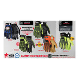 A display features five pairs of MCR Safety Blue ForceFlex Multi-Task Gloves B100 in assorted colors and styles, with labels noting abrasion and heat resistance, reinforced synthetic leather palms, grip, and budget-friendly options.
