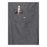 Close-up of a gray MCR Summit Breeze 5.5 oz FR Shirt SBS100_ pocket with flap, button, and pen. A black and red "MCR Safety" label above the pocket highlights arc flash protection for enhanced safety.
