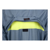 Close-up of the back of an MCR Summit Breeze 5.5 oz FR Shirt SBS100_ by MCR Safety, showing a flap that reveals a bright yellow mesh ventilation panel with triple vent technology and a sewn black label.