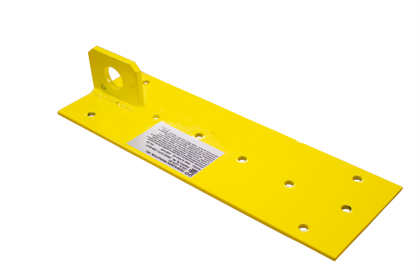 The French Creek Reusable Single Plate Roof Anchor MRA-R1, produced by French Creek Production, is a yellow rectangular metal bracket designed for roof anchoring. It has a mounting hole at one end and multiple smaller holes for bolts. A white label on the surface indicates its suitability for reusable fall protection applications.