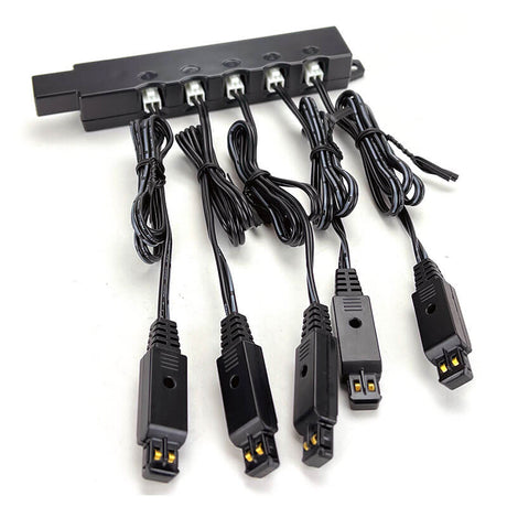 The RKI Instruments 5-Unit Charging Connector Bar w/Charging Cables (47-5102) features five charging connectors and cables, ideal for powering gas detection units like GX-3R monitors, shown arranged on a white background.
