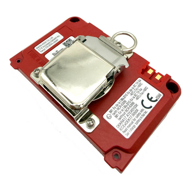 Red electronic device from RKI Instruments, equipped with a metallic hinged protective cover and multiple white labels displaying technical information and certification markings. This unit features the RKI Li-Ion Battery Pack w/Alligator Clip (49-1625-01), ensuring convenient, uninterrupted operation thanks to its hot-swappable design. Three gold connectors are located on the right side of the device.