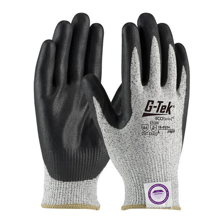 The image shows a close-up of protective gloves featuring black nitrile-coated grips and gray knit fabric on the back. Branded with "PIP - Protective Industrial Products," these PIP G-Tek ECO Dyneema Phoenix Gloves provide excellent cut resistance, with safety standards clearly marked on the back.