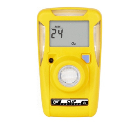 A yellow handheld gas detector displaying "24 MM" on a small screen. It has a circular sensor in the center and a label at the bottom with "Clip" and "O2" written on it.