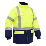 The PIP Bisley X-Back Extreme Cold Jacket w/Navy Bottom 343M6450X, by Protective Industrial Products, is a high-visibility garment with bright yellow fabric and reflective stripes. It provides thermal insulation for protection against extreme cold. The jacket features a high collar, long sleeves with black cuffs, and a navy fabric on the lower part. Convenient pockets are visible on the chest and sides.