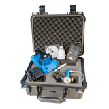 The GfG EcoBump Kit with Rechargeable G450-11420E includes a variety of electronic devices, featuring a blue device, cables, and a G450 gas monitor. This portable case is equipped with rechargeable battery packs and securely holds its contents in foam compartments, allowing the contents to be clearly displayed when open.