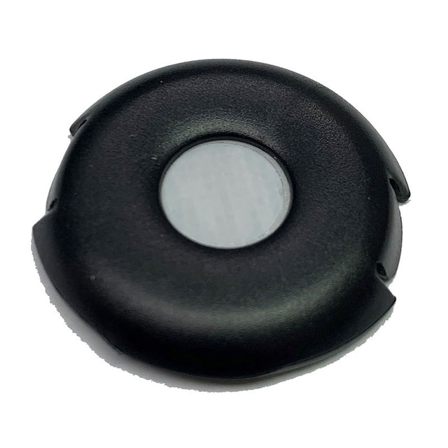 The item depicted is an mPower Electronics External Hydrophobic Filter Clip with Filters (Model M001-3006-000), featuring a round, black plastic design that resembles gas monitor components. It has a central gray circular section surrounded by a black outer ring, which includes small indentations along the edge. The surface is smooth and slightly reflective, standing out against a plain white background.