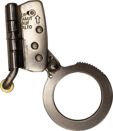 A close-up image of a single metallic handcuff, open to reveal its locking mechanism. The polished metal is reflective, with "UP" and "HAUT" engraved near the hinge, reminiscent of the precision seen in the French Creek Stainless Steel Rope Grab with Safety Lock 1201N by French Creek Production used for fall protection.