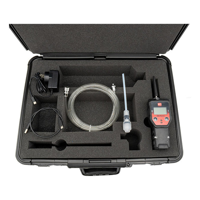 The RKI Instruments GX-Force 4 Gas Monitor with Case (72-FA-A-A10-50) includes a hard case, foam inserts, charger, USB cable, coiled tubing, probe, and adapter—organized for multi-gas detection in confined spaces.