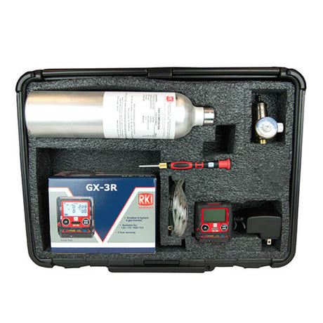 The RKI GX-3R 4 Gas Confined Space Kit by RKI comes in a carrying case with a silver cylinder, digital gas monitor, user manual, screwdriver, and various accessories all organized neatly in foam compartments—perfect for ensuring safety in confined spaces.