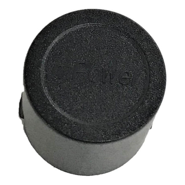 A slightly elevated angle reveals a black circular object featuring the embossed text "dPow" and a textured finish. This object resembles a small cap or lid, likely part of an mPower Electronics device, specifically the MP420 Replacement Dummy Sensor used for training purposes.