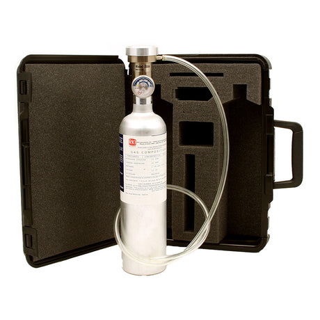 Displayed in front of an open black carrying case with custom foam padding, tailor-made for the RKI GX-2012 Calibration Kit by PK Safety Supply, is a silver gas cylinder featuring a pressure gauge and attached tubing. The case includes a handle on the right side to facilitate easy transport.