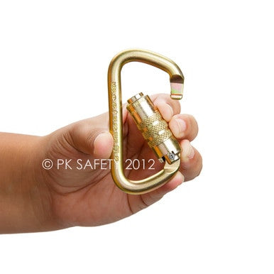 A hand holds a Skylotec Little D steel carabiner with a 1/2 in. gate opening, featuring a locking mechanism and showcasing its durable gold-colored design against a plain white background. The carabiner is branded with "Skylotec.