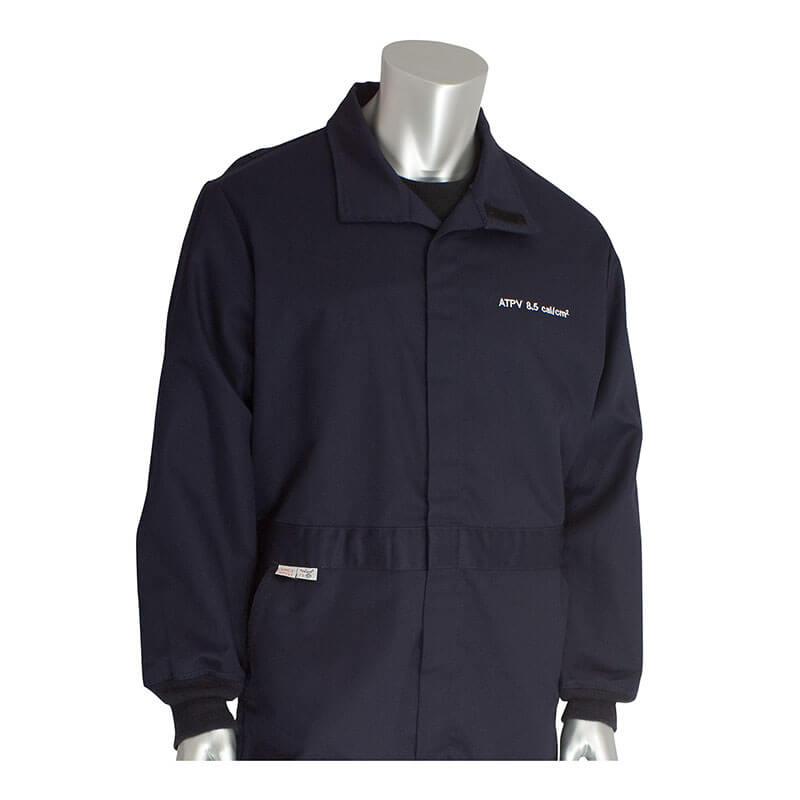 A silver, featureless mannequin wears a PIP Navy 8.5 Cal Dual Certified ARC/FR Coverall 9100-2160D with a collar, front zipper, chest patch, and waist tag.