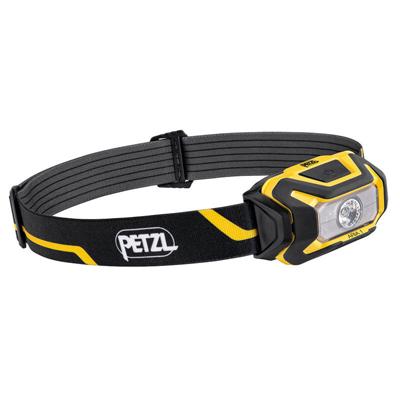 Introducing the Petzl ARIA 1 Headlamp E069AA00, a yellow and black waterproof headlamp featuring an adjustable strap adorned with the iconic Petzl logo. This compact, rectangular lamp boasts a single central round light, perfect for hands-free use.