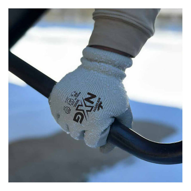 Someone wearing MCR Safety Memphis Flex-Therm Glove 9690 from MCR Safety firmly grips a black metal bar outdoors, with snow and a blurred background in view—demonstrating the crucial protection and warmth these cold weather work gloves provide.
