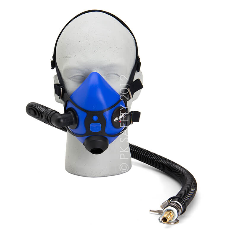 A gray mannequin head showcases the Allegro Half Mask Constant Flow Airline Respirator 9920 from PK Safety Supply, featuring a blue silicone facepiece with attached hoses. This half-mask design includes multiple adjustable straps and a side breathing apparatus, with the hose extending outward to highlight its continuous airflow and connection point.