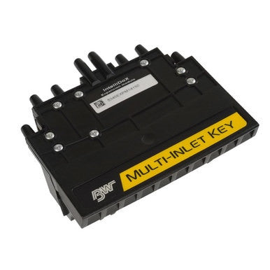 A black rectangular BW IntelliDoX Multi-Inlet Key DX-MI-KEY device from BW Honeywell, featuring several ports and visible screws, resembles an IntelliDoX docking station. It includes a yellow label with the text "MULTI-INLET KEY" and a logo displaying the letters "BW.