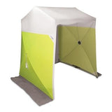 The Allegro Confined Space Deluxe Work Tent - 2 Door 9402, featuring a flexible frame and an open entrance, is set up. Its design with a white roof and green walls makes it ideal for camping, beach use, or as a confined space work station for manhole entry tasks.