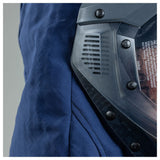 Close-up of a person in a blue jacket wearing the NSA Enespro ArcGuard Performance 40 Cal Lift Front Hood (ARC40H), featuring visible screws, ventilation slits, clear visor, safety instructions, and protective Arc Flash Clothing.