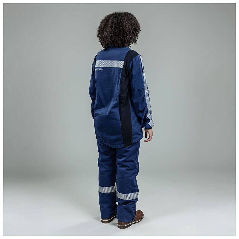 A person with curly hair, seen from behind, is wearing an NSA Enespro ArcGuard Performance 40 Cal Arc Flash Jacket ARC40J with reflective stripes and brown shoes, standing against a plain gray background.