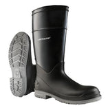 The Dunlop PolyGoliath Plain Toe Boots 89680 in black, featuring a gray sole, embody durability. The left boot highlights the textured tread pattern tailored for chemical resistance, while the right boot stands upright, proudly displaying the iconic "Dunlop" brand on its side, epitomizing reliable protective footwear.