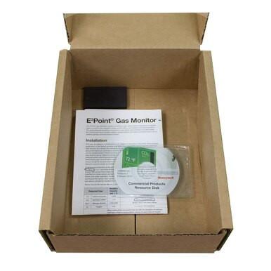 A cardboard box contains the installation guide for the Honeywell E3Point Network Single Gas Monitor 1309A004, a CD labeled "Connected Products Resource Disk," and a small black accessory, all designed to integrate seamlessly into your Building Automation System. Experience Honeywell Analytics’ dedication to safety and innovation with every component.