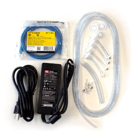 On a white surface, there is an assortment of items including a coiled blue CAT 6 cable, a black power adapter with cords, clear hoses, plastic connectors, and small washers. Among them is the BW IntelliDoX Enabler Kit DX-ENBL-NA from PK Safety Supply for streamlined device management.