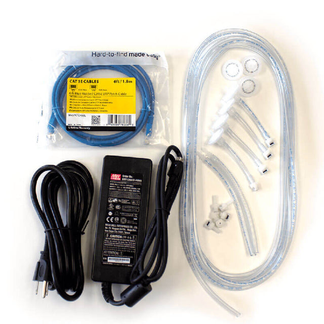 On a white surface, there is an assortment of items including a coiled blue CAT 6 cable, a black power adapter with cords, clear hoses, plastic connectors, and small washers. Among them is the BW IntelliDoX Enabler Kit DX-ENBL-NA from PK Safety Supply for streamlined device management.