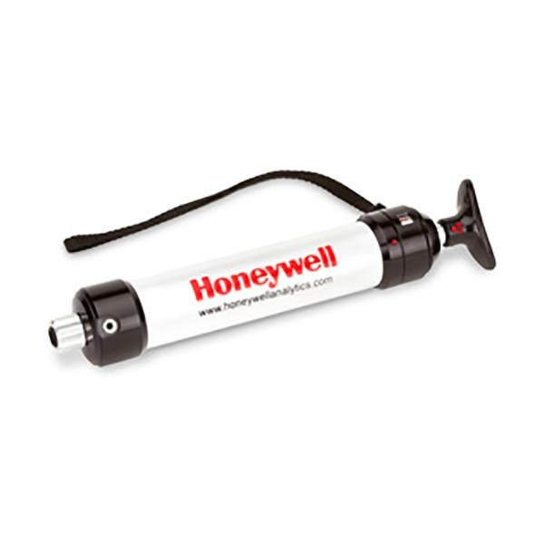 The BW Honeywell Piston Hand Pump is a white manual air sampling device with a black handle and nozzle, equipped with a convenient carrying strap. It's designed for use with gas detection tubes, making it perfect for accurate measurements. The brand name "BW Honeywell" is prominently displayed in bold red print.