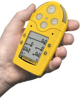 A hand holds the yellow BW Honeywell GasAlert Micro 5 Multi-Gas Monitor (M5-XW0Y-R), its digital display showing numeric readings for various gas levels. This device, essential for workplace safety, features several circular sensor openings at the top.