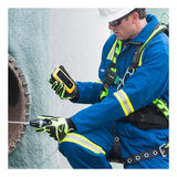 Wearing safety gear and a helmet, a worker uses the BW Technologies by Honeywell BW Ultra Five-Gas Portable Gas Detector HU-X1W1H1M1 with a probe to inspect the interior of an industrial pipe or tank.