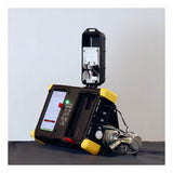 The WatchGas SST Dock Bundle by WatchGas, with yellow edges and a touchscreen, features metal connectors and an open lid revealing components for bump test or calibration gas on a dark surface.