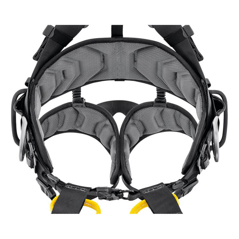 A close-up of the Petzl Volt International Version Harness (C072CB0_), a padded black and gray fall-arrest harness with adjustable straps, metal rings, and buckles by Petzl, designed for secure support and comfort during tower work at height.