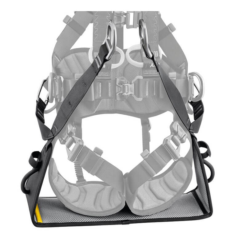 The Petzl VOLT International Version Work Seat C072EB00 is a black padded harness accessory by Petzl, designed for work positioning with metal rings and secure straps. The image shows the seat attached in front of a safety harness.