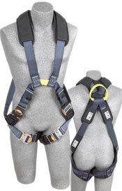 Two mannequin torsos showcase the DBI-SALA Exofit XP Cross-Over Style Arc Flash Harness 1110870 by 3M DBI-SALA Fall Protection. This harness, in blue and black, includes padded shoulders, durable buckles, and straps that secure around the torsos and legs. From the back view, a yellow attachment ring is visible near the neck area, ensuring uncompromised safety.