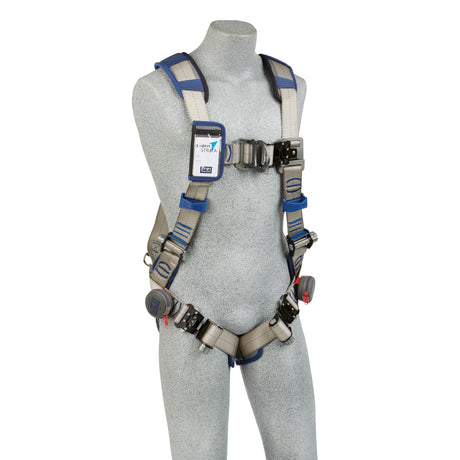 A gray mannequin wears a 3M DBI-SALA ExoFit STRATA Vest-Style Climbing Harness from 3M DBI-SALA Fall Protection, showcasing blue and gray straps with metallic buckles. The harness includes a label on the chest area and features adjustable straps at the shoulders, chest, and thighs.