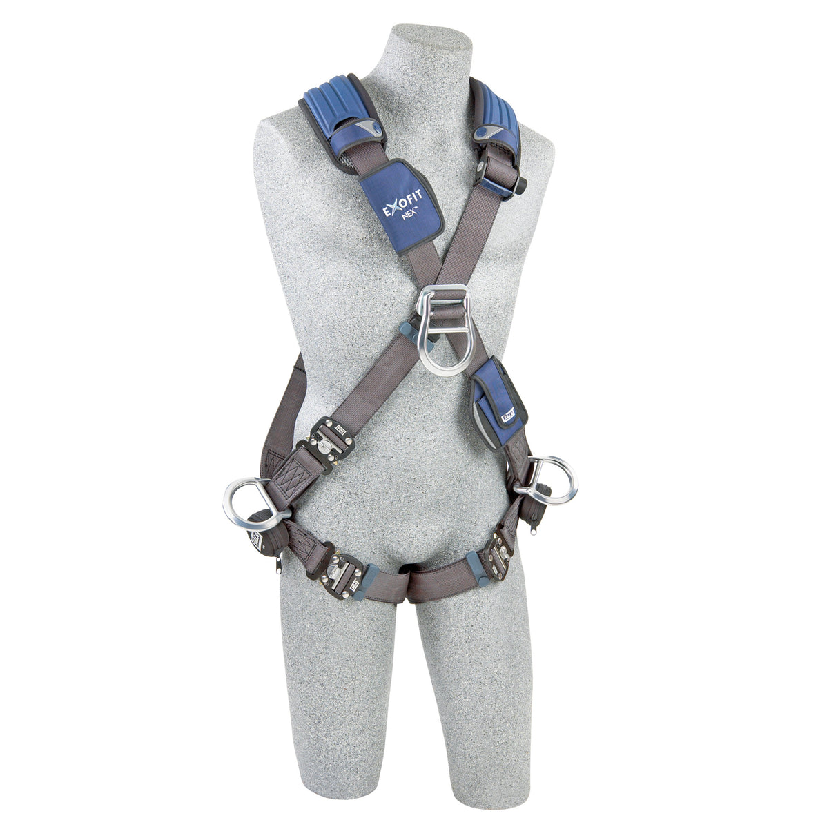 A gray mannequin is dressed in a black 3M DBI-SALA Fall Protection ExoFit NEX Cross-Over Positioning/Climbing Harness, showcasing adjustable straps, metal buckles, and rings. The harness is equipped with blue comfort padding on the shoulders and displays a logo on the chest area. The mannequin is set against a white background.