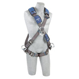 A gray headless mannequin displays the 3M DBI-SALA Fall Protection ExoFit NEX Cross-Over Positioning/Climbing Harness, featuring metal buckles and blue comfort padding around the shoulders. This harness includes multiple attachment points for safety equipment, providing both security and ease of movement.