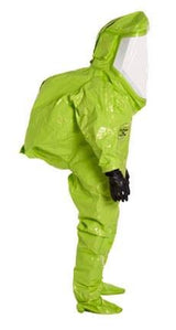 The individual is dressed in a DuPont Tychem 10000 Commander EX Level A Suit TK555T, featuring a vivid green color and equipped with a transparent face shield as well as black gloves. The completely enclosed design offers superior protection.