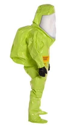 A person in a vibrant green DuPont Tychem 10000 TK587S HazMat Training Suit, featuring integrated gloves and a transparent face shield. The suit fully covers the body from head to toe as the individual stands in profile view.