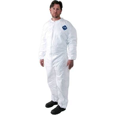 A person stands wearing a Dupont Tyvek 400 TY125S Coverall Suit in white, along with black shoes. The suit features a small blue logo on the chest and is designed for protection against hazardous materials. The background is plain white.